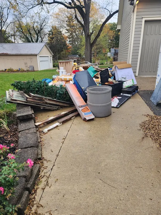 Dumpster being loaded with debris for Roofing Dumpster Rental in Cambridge